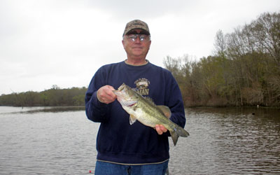 <p>Jim with one of his Caney Bay bass caught on a small spinner</p>